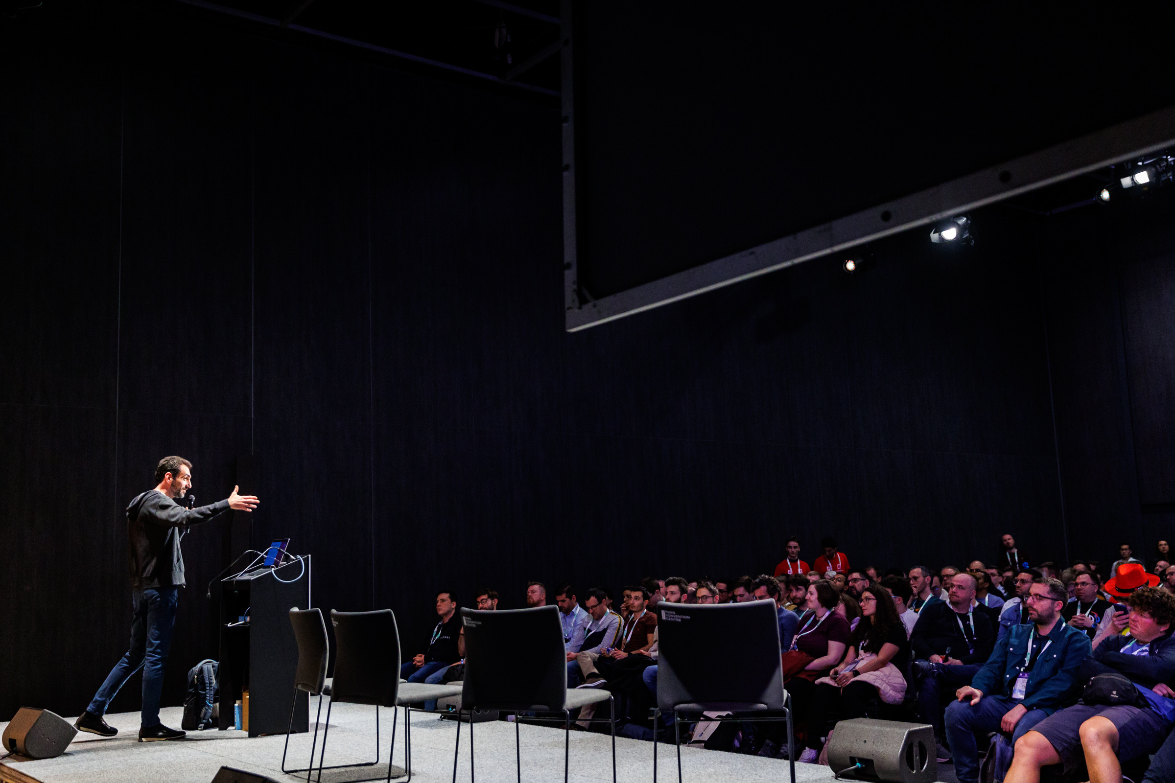 Stefan Prodan speaking to a crowd at KubeCon